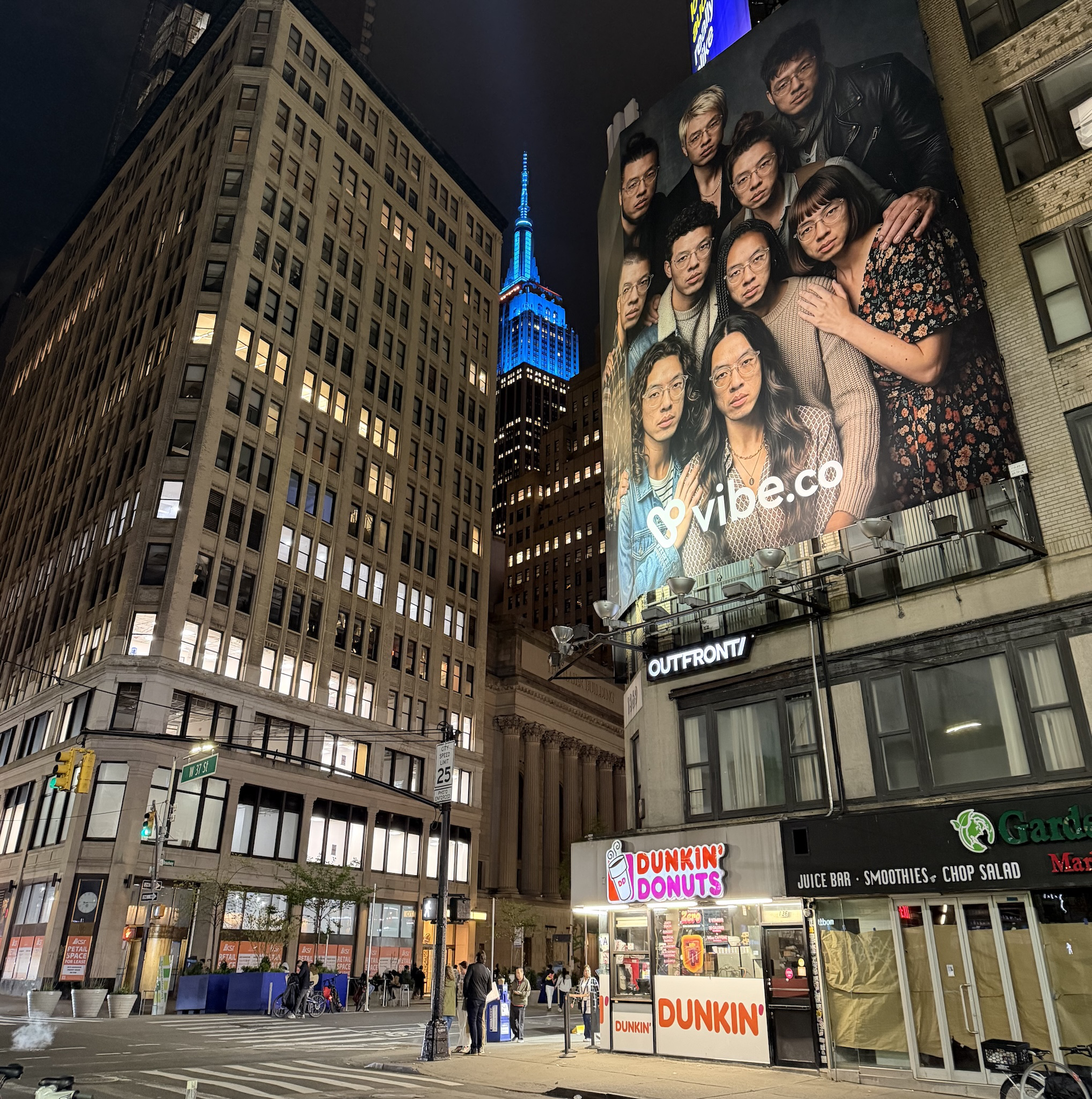 A Vibe.co billboard with the Empire State Building in the background